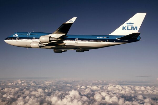 Boeing klm flying high in the sky above the clouds