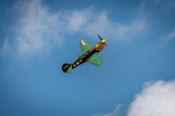 Flying in the clouds of a retro fighter on parade