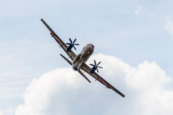 Ein großes Flugzeug fliegt vor einem Hintergrund von Wolken