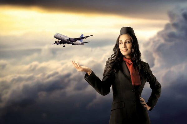 Flight attendant on the background of the sky and a flying plane