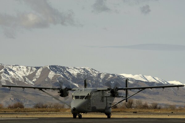 Plane at the airport against the background of mountains