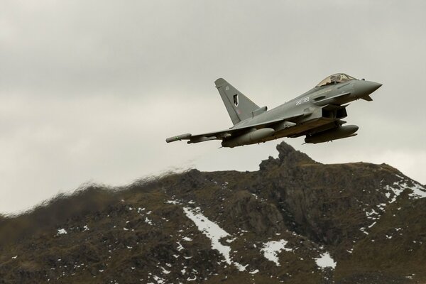 Powerful raf typhoon over mountain peaks