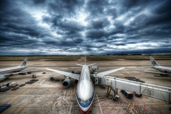 Avion de passagers à l aéroport sur fond de ciel orageux