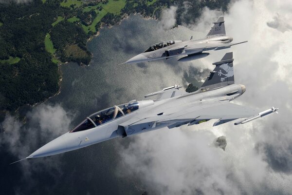 Scenic flight of jas 39 fighters over the landscape