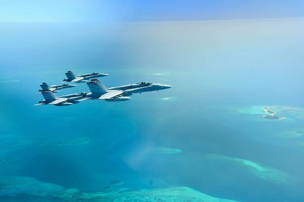 FA-18 military fighters in the air over the ocean