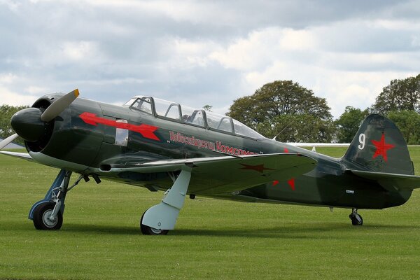 Soviet training fighter Yak-11 on the green field