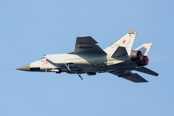 Two-seat mig-31 fighter jet on a blue sky background