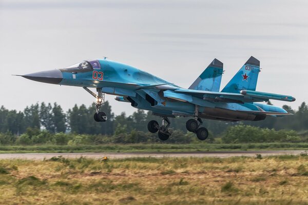 The take-off of the su-34 fighter bomber over the airfield