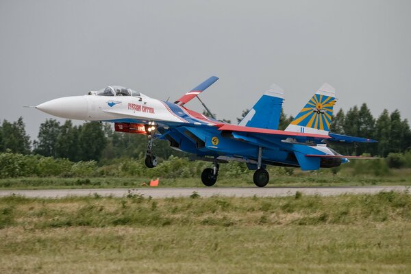 The take-off of a fighter at the airfield against the background of the forest