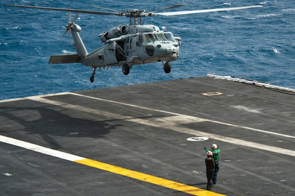 Landing of a black hawk on an aircraft carrier