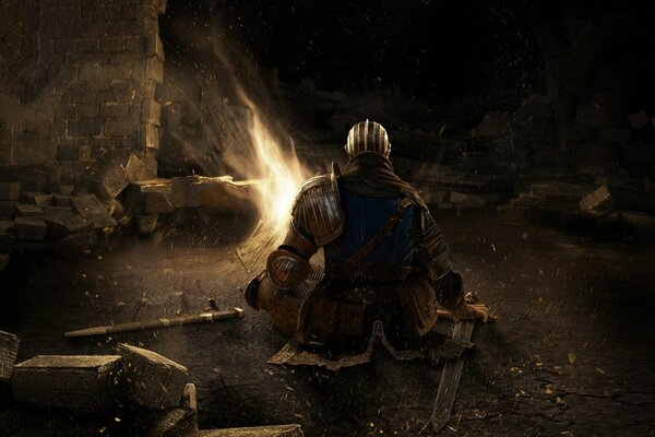 A knight in armor with a sword is sitting on the ground