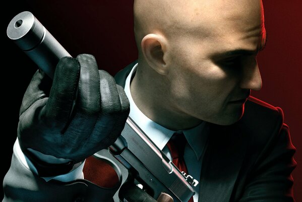 A pistol with a silencer and a gloved hand