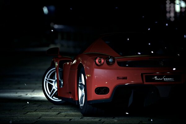 Rear view of a red Ferrari at night