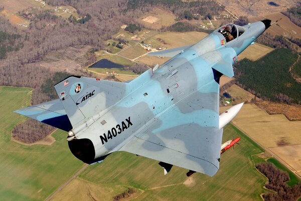 Military single-seat aircraft with tail number N403AX in flight