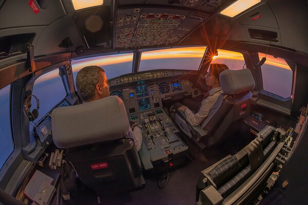 Cockpit in an airbus, dawn, man and woman