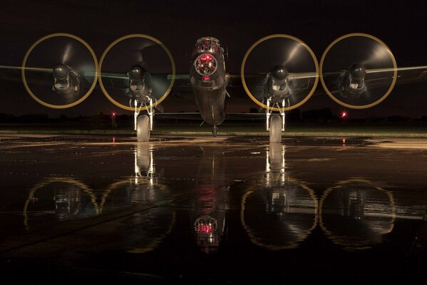 Four-engine heavy bomber on the runway at night