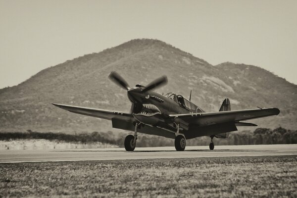 P-40 Warhawk fighter at the airfield in the mountains