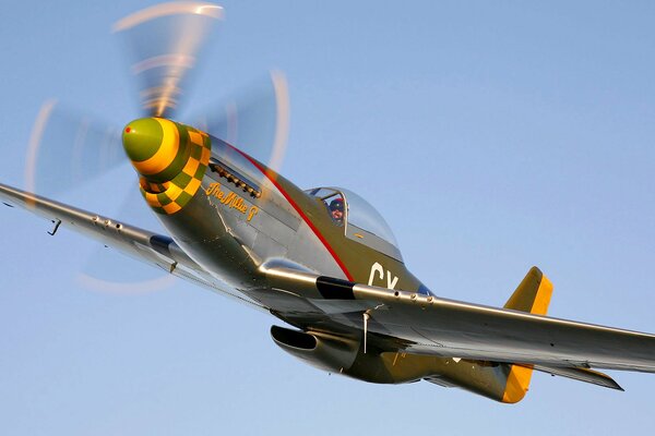 Retro airplane in the sky with a big propeller