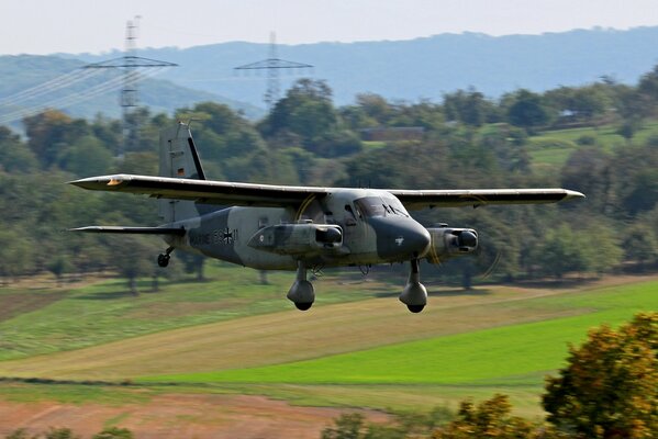 Y 28d skyservant german plane flies over fields