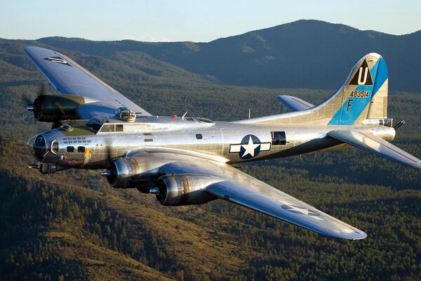 One bomber over the forest and mountains