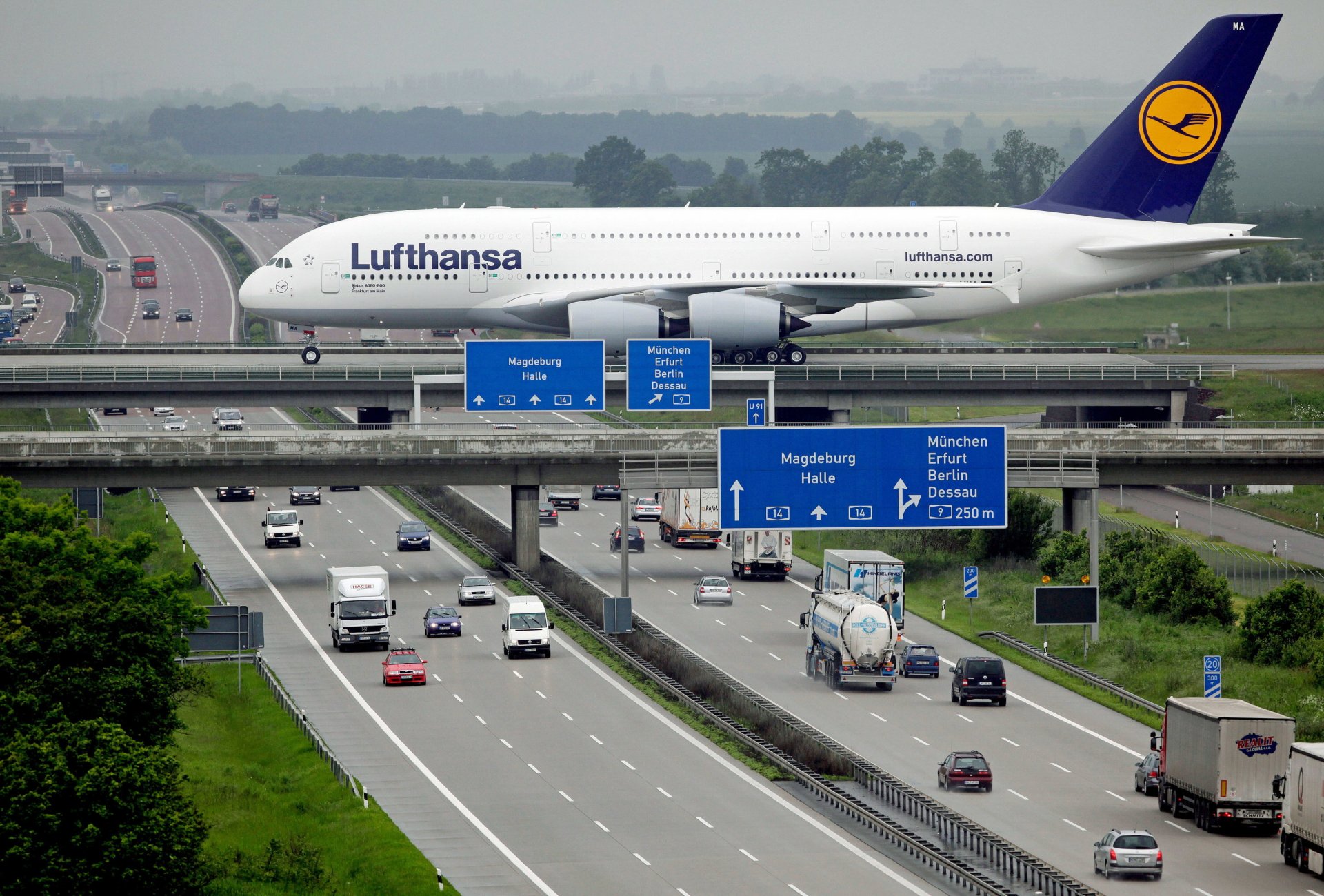 lufthansa airbus a380 lufthansa passenger airliner airplane city road bridge autobahn cars passenger airplane highway car