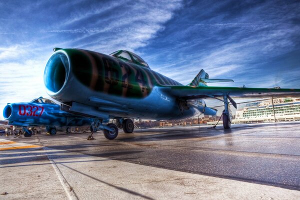 There is a fighter jet on the blue background of the sky