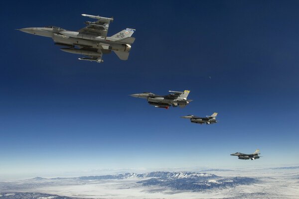 Fighters four planes over snow-capped peaks