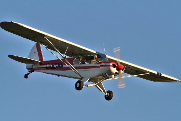 An American two-seater plane is flying in the sky