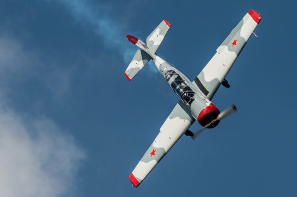 Yak-52 aircraft in the sky making a turn