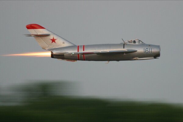 The gray mig-15 is rushing across the sky at the speed of light