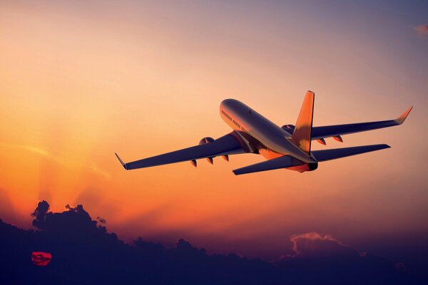 Das Flugzeug fliegt bei Sonnenaufgang in den Himmel