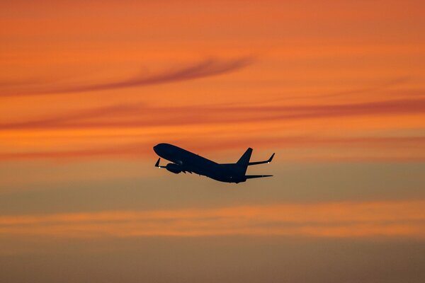 Passagierflugzeug am Himmel bei Sonnenuntergang