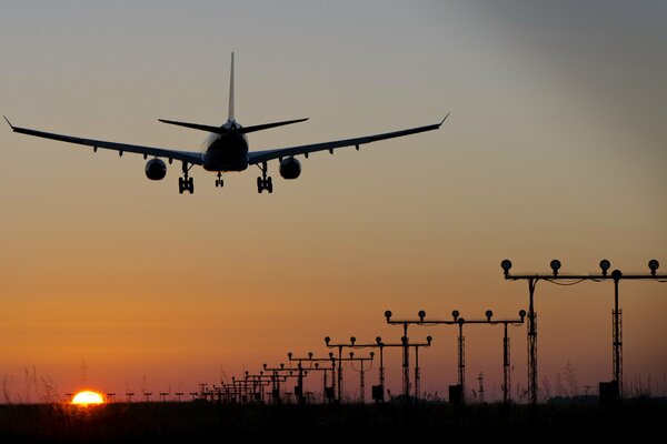 Schönes Foto des Flugzeugs. Das Flugzeug landet. Flugzeug bei Sonnenuntergang