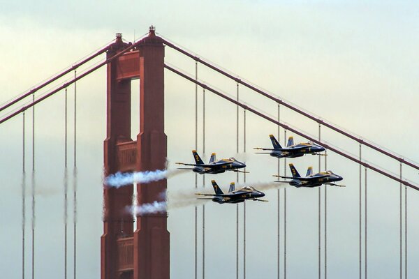 Blue planes flying over the big bridge