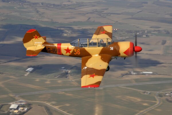 All-metal Yak-52 aircraft in the sky