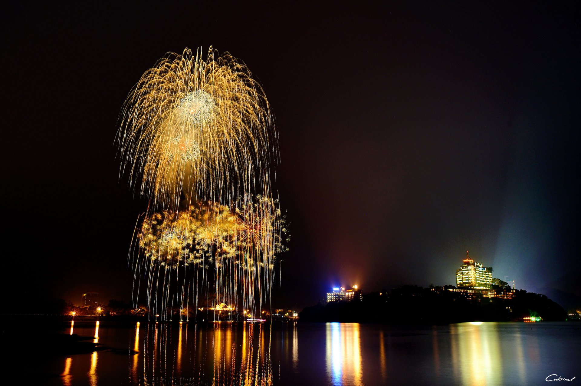 night fireworks lights town reflection lake