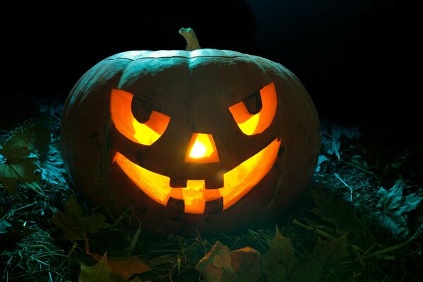 A face in a pumpkin with a candle for Halloween