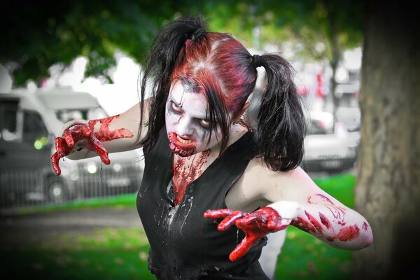 A girl in a bloody zombie costume