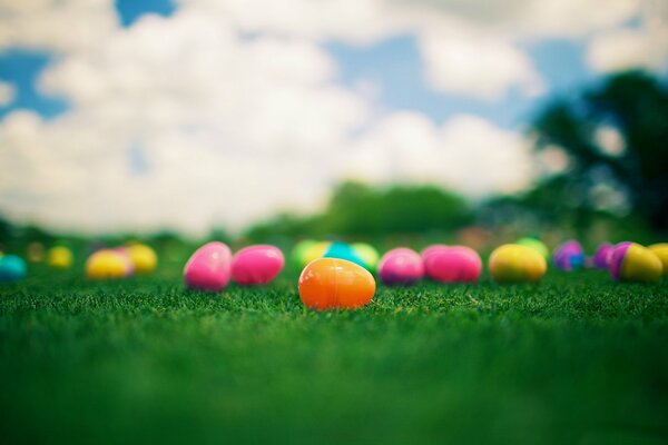 A scattering of bright Easter eggs on the grass