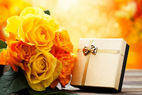 Yellow roses and a gift in a box