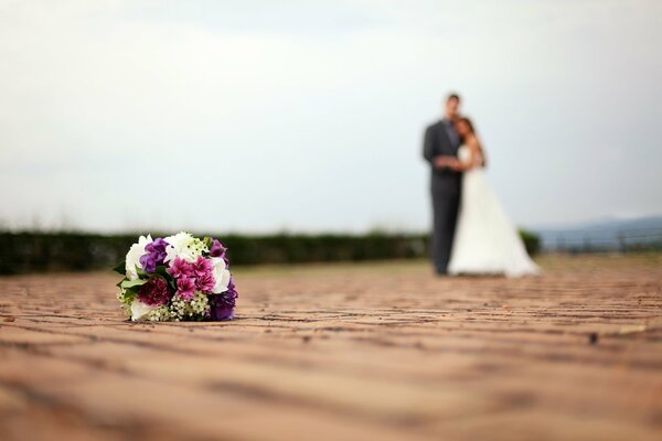 The bride in a wedding dress and the groom in a suit