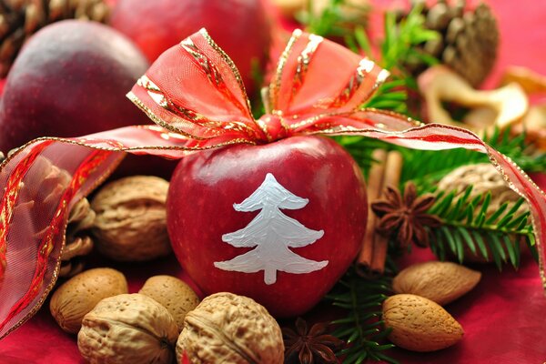 New Year s still life with painted apple, cinnamon, pine needles and ribbons