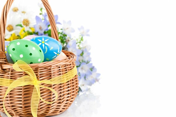 Colored Easter eggs lie in a wicker basket