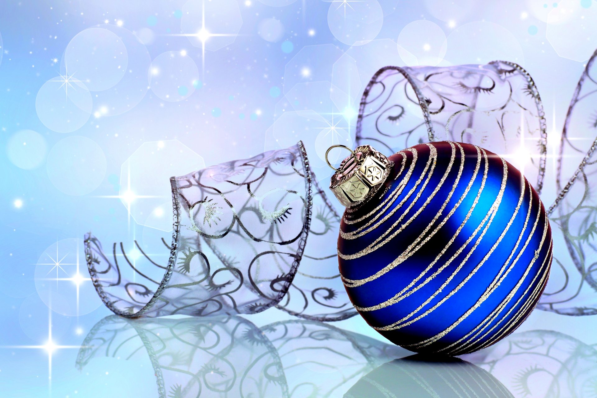 new year holiday ball blue toys ribbon reflection reflections background close-up