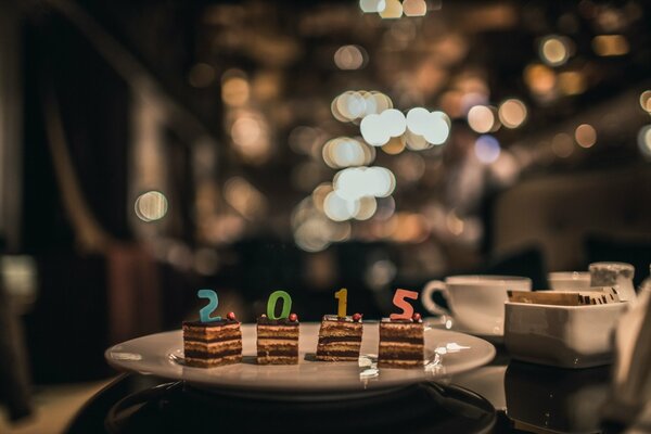 Pieces of cake with candles on a plate