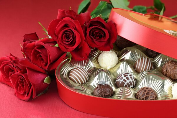 Photo romantique avec des fleurs et des bonbons au chocolat