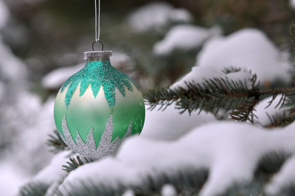 Christmas tree toy on a snow-covered Christmas tree