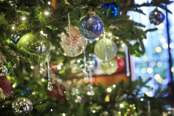 Bolas de Navidad y carámbanos en una rama de abeto