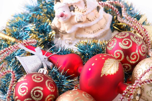 Bolas rojas de Navidad y la parte superior del árbol de Navidad entre oropel