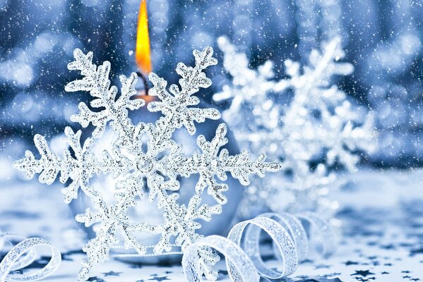 Frosty Snowflakes and a burning candle